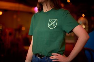 View of pub swag green t-shirt with logo on front