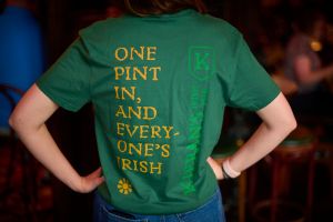 View of gold wording on the back of the green pub swag Kieran's Irish Pub t-shirt