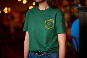 View of pub swag t-shirt with gold logo